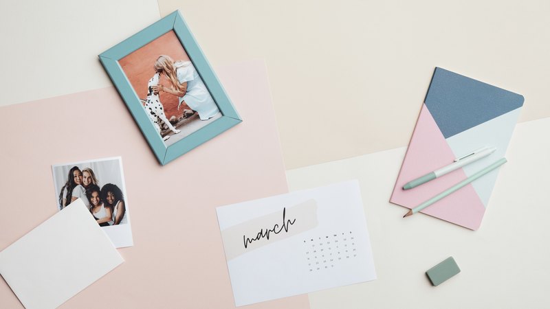 A wall calendar and an open notebook on a nursery office desk